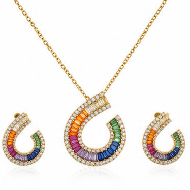 Gold necklace and matching earrings with curved horseshoe-shaped pendants featuring a rainbow of colored stones and clear pavé accents, shown on a white background.