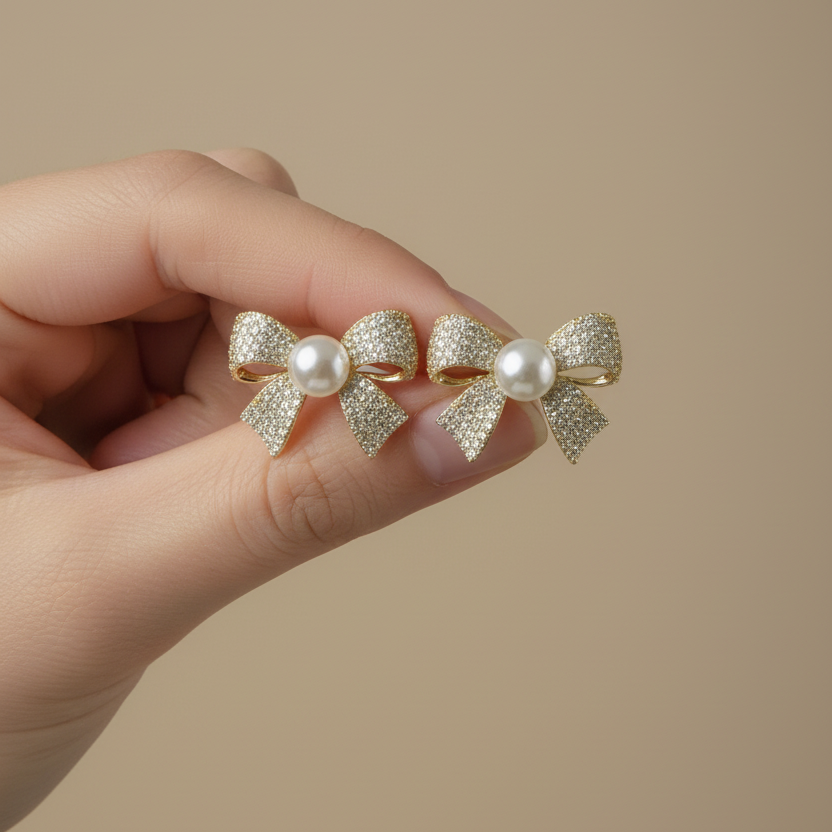 Bow and Pearl Stud Earrings in hand by SVORA