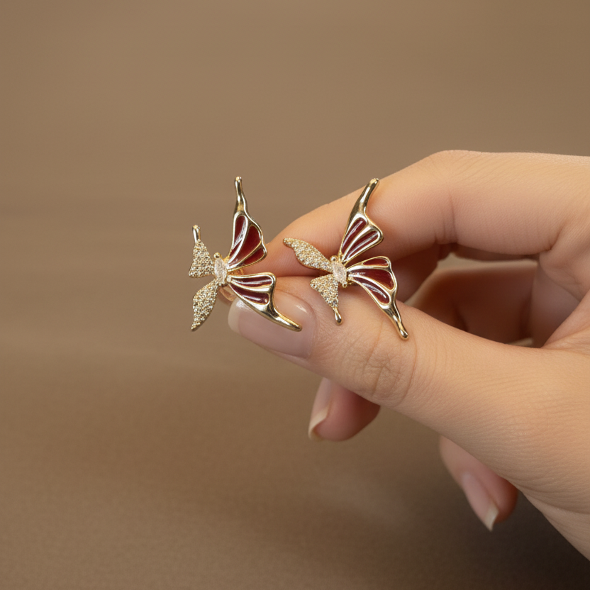 Red Butterfly Stud Earrings hand shot by SVORA