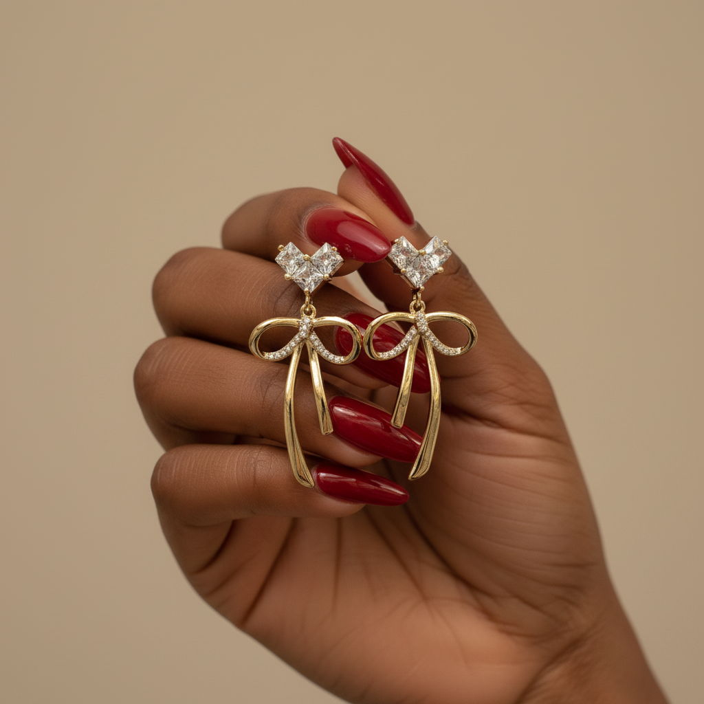 Heart and Bow Dangler Earrings in hand by SVORA