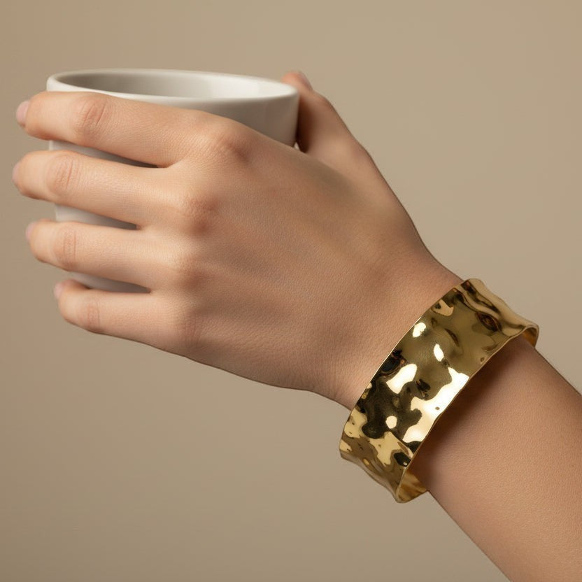 SVORA wide hammered gold cuff bracelet made of 18K gold plated stainless steel, adjustable and waterproof.