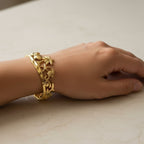 SVORA gold plated stainless steel Seascape cuff bracelet with palm tree, starfish, shell, and turtle motifs.