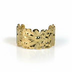 SVORA gold plated stainless steel cuff bracelet with a detailed floral pattern. Adjustable and hypoallergenic.