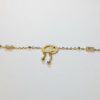 SVORA gold plated stainless steel bracelet with three heart charm, baguette CZs, and dangling beads. Adjustable.