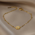 SVORA gold plated stainless steel daisy chain bracelet with a clear cubic zirconia stone. Adjustable lobster clasp.