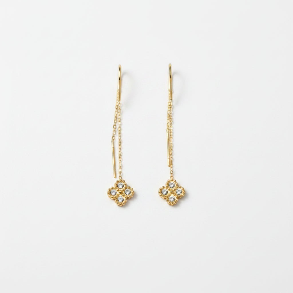 SVORA gold thread-through earrings with cubic zirconia clover charms and delicate chains.