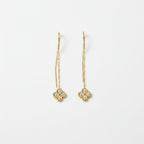 SVORA gold thread-through earrings with cubic zirconia clover charms and delicate chains.