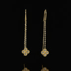 SVORA gold tone stainless steel thread-through earrings with cubic zirconia clover charms.