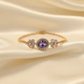 SVORA Amethyst oval layered bracelet with CZ halo and purple flower accents on a rose gold chain. Waterproof and anti-tarnish.