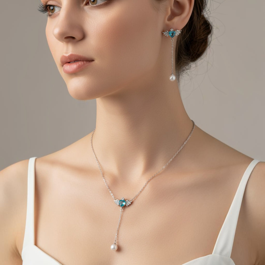 SVORA Angel Aqua Asymmetric Necklace Earrings Set with blue crystal hearts and pearl drops, silver-tone.