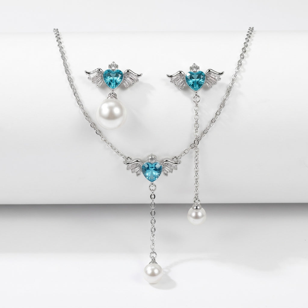 SVORA Angel Aqua Asymmetric Necklace Earrings Set with blue crystal hearts, pearl drops, and silver-tone finish.