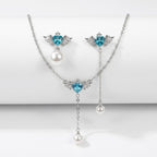 SVORA Angel Aqua Asymmetric Necklace Earrings Set with blue crystal hearts, pearl drops, and silver-tone finish.