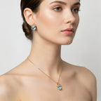 SVORA gold-tone necklace and earrings set with aqua cushion-cut crystals and pavé bow details.