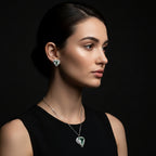 SVORA aqua heart necklace and earrings set with silver-tone pavé wings and crown detail. Features aqua crystal cubic zirconia.