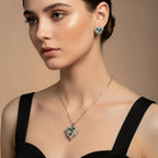 SVORA aqua heart necklace and earrings set with silver-tone pavé wings and crown detail. Features aqua crystal cubic zirconia.
