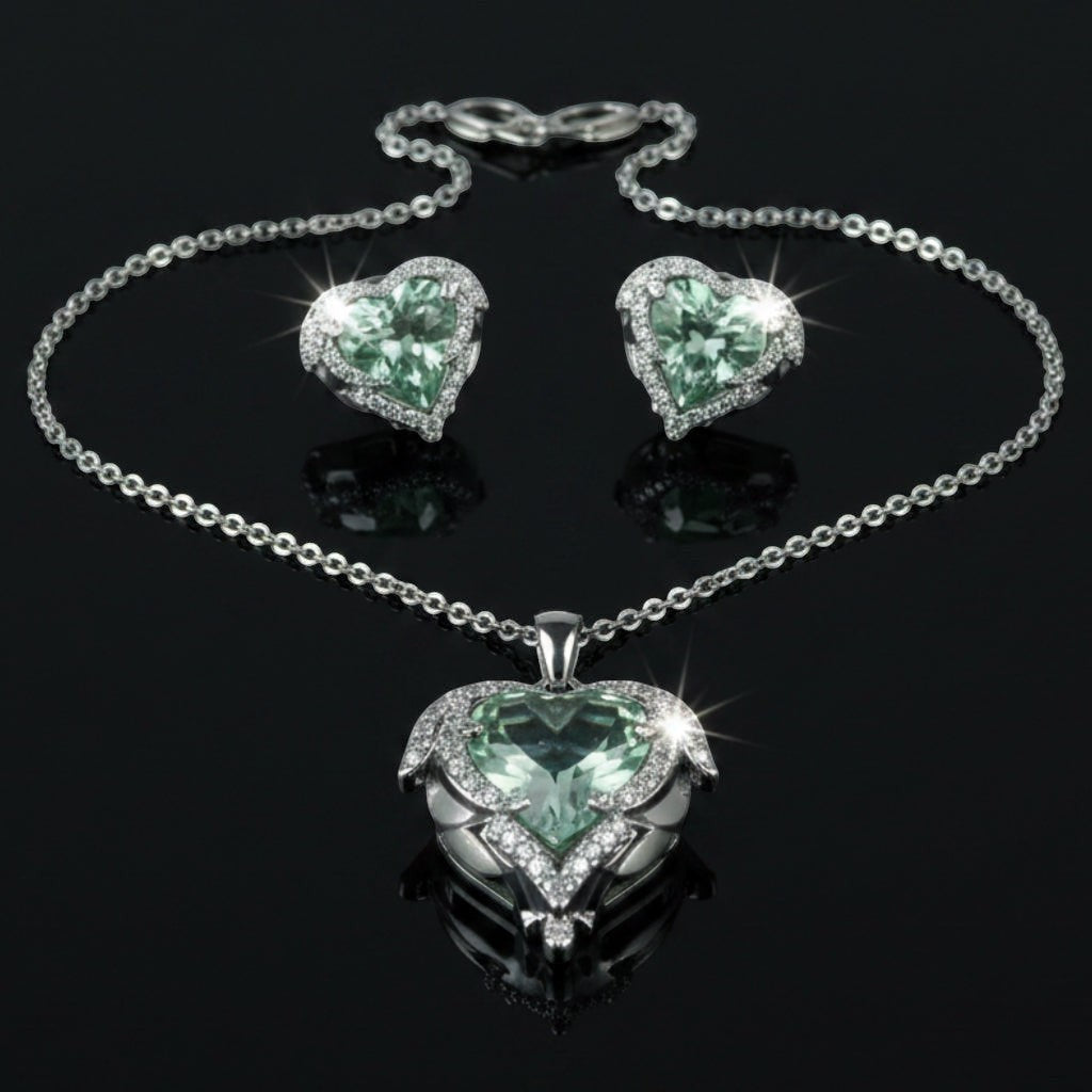 SVORA aqua heart necklace and earrings set with pave wings and crown detail. Silver-tone.
