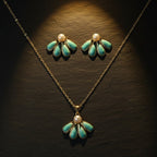 SVORA sea-green enamel fan flower necklace and earrings set with gold detail and pearl accent.