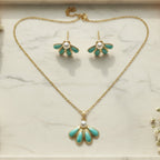 SVORA gold-tone necklace and earrings set with sea-green enamel fan pendants and pearl accents.