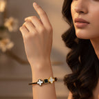 SVORA black onyx and white mother-of-pearl clover and square charm bracelet on gold band.