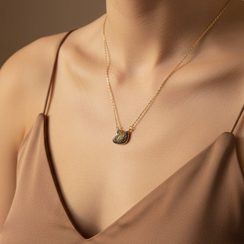 SVORA gold plated stainless steel necklace with a black swan pendant pavé-set in jet-black CZ.
