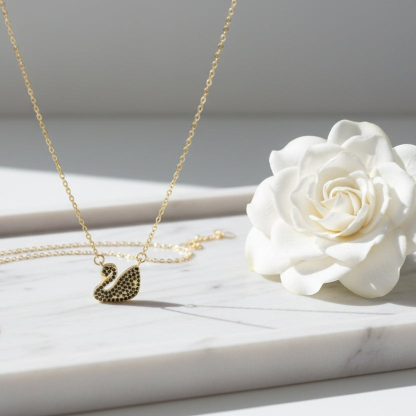 SVORA gold plated stainless steel necklace with black CZ swan pendant. Waterproof, anti-tarnish.
