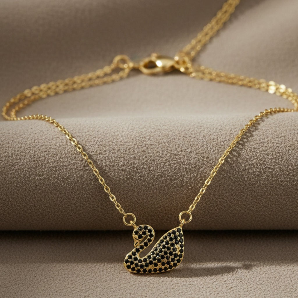 SVORA gold plated stainless steel necklace with a black swan pendant pavé-set in jet-black CZ.