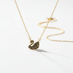 SVORA gold plated stainless steel necklace with a black swan pendant pavé-set in jet-black CZ.