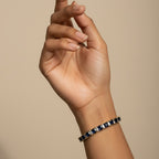 SVORA adjustable tennis bracelet with deep blue sapphire and clear baguette stones, 18k gold-plated stainless steel.
