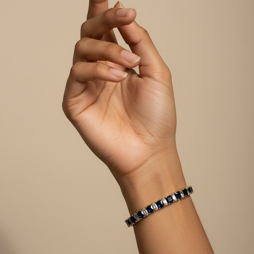 SVORA adjustable tennis bracelet with deep blue sapphire and clear baguette stones, 18k gold-plated stainless steel.