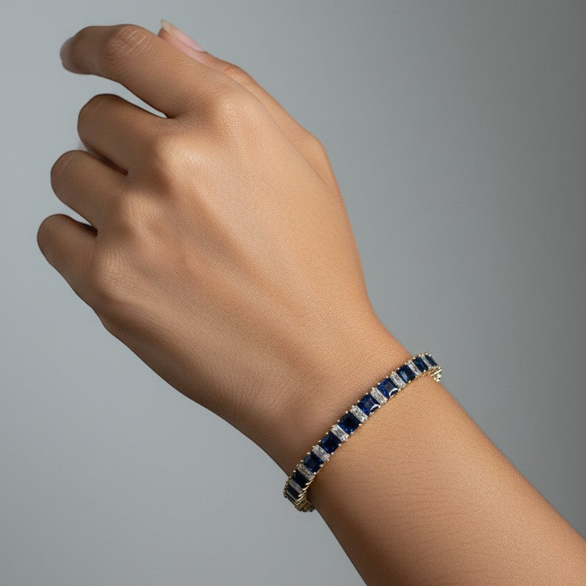 SVORA 18k gold-plated stainless steel tennis bracelet with blue sapphire and diamond accents.