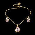 SVORA gold tone necklace and earrings set with blush pear-cut crystals. Minimalist jewelry.