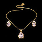 SVORA gold tone necklace and earrings set with blush pear-cut crystals. Minimalist jewelry.