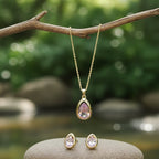 SVORA blush pear-cut crystal pendant necklace and matching stud earrings set in gold-tone stainless steel.