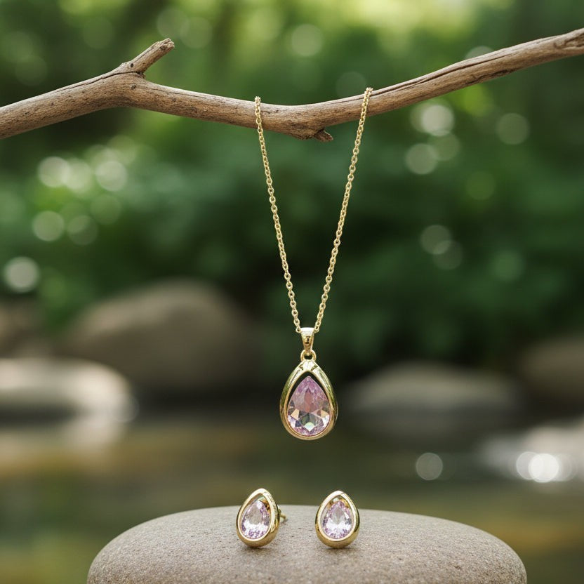 SVORA blush pear-cut crystal pendant necklace and matching stud earrings set in gold-tone stainless steel.