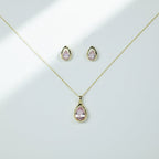 SVORA blush pear-cut crystal pendant necklace and matching stud earrings set in gold-tone stainless steel.