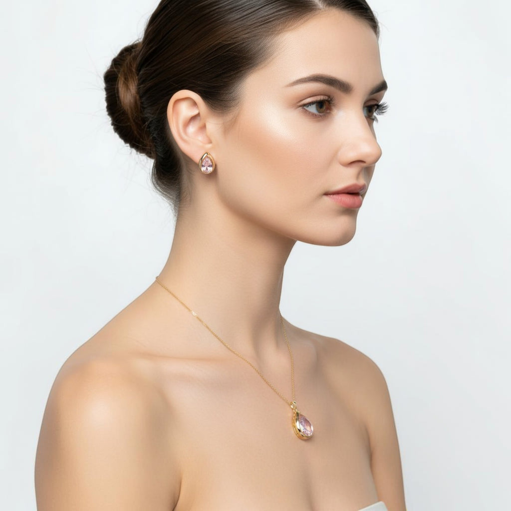 SVORA gold-tone stainless steel necklace and stud earrings set with blush pear-cut crystals.