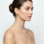 SVORA gold-tone stainless steel necklace and stud earrings set with blush pear-cut crystals.