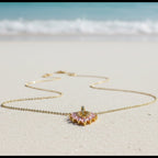SVORA gold chain necklace with a blush pink marquise leaf pendant adorned with white CZ stones.