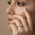 SVORA gold tone ring with a square-cut blush pink stone and geometric links. 18K gold plated stainless steel.