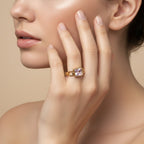 SVORA gold-tone ring with a square-cut blush pink stone and open square link band. Modern Deco style.