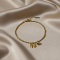 SVORA gold-plated stainless steel bracelet with a bow charm and ball bead chain. Adjustable with lobster clasp.
