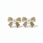 SVORA gold-tone bow stud earrings with pearl center and pavé crystal details