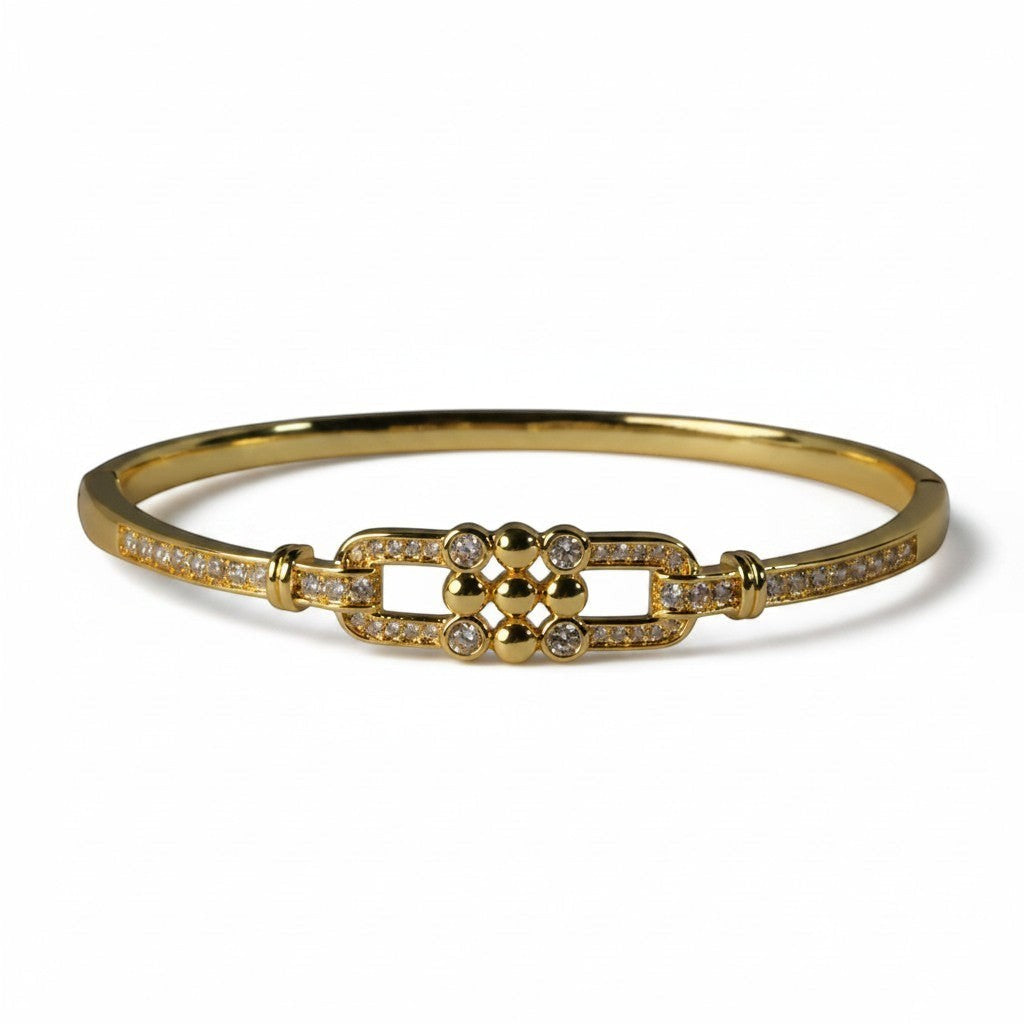 SVORA gold-plated stainless steel bangle bracelet with buckle detail and CZ stones. Waterproof and anti-tarnish.