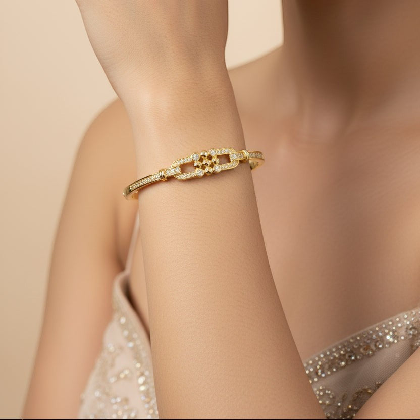 SVORA gold-plated stainless steel bangle bracelet with buckle cluster and CZ stones. Waterproof and anti-tarnish.