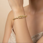 SVORA gold-plated stainless steel bangle bracelet with buckle cluster and CZ stones. Waterproof and anti-tarnish.