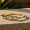 SVORA gold-plated stainless steel bangle bracelet with buckle cluster and CZ stones