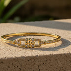 SVORA gold-plated stainless steel bangle bracelet with buckle cluster and CZ stones