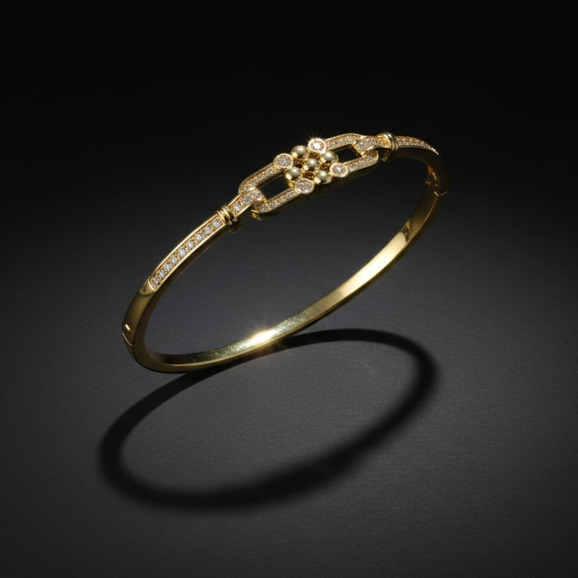 SVORA gold-plated stainless steel bangle bracelet with buckle cluster and CZ stones