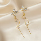 SVORA gold tone stainless steel dangle earrings with cubic zirconia butterfly tops and dual chains.