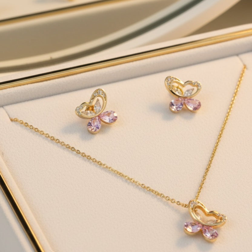 SVORA gold tone necklace and earrings set with butterfly pendants, cubic zirconia, and pink crystal teardrops.